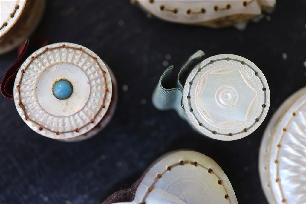 Eight assorted 19th century mother of pearl mounted pin cushions